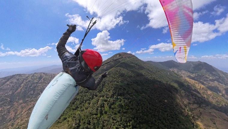 Cross-country paragliding line above alpine terrain